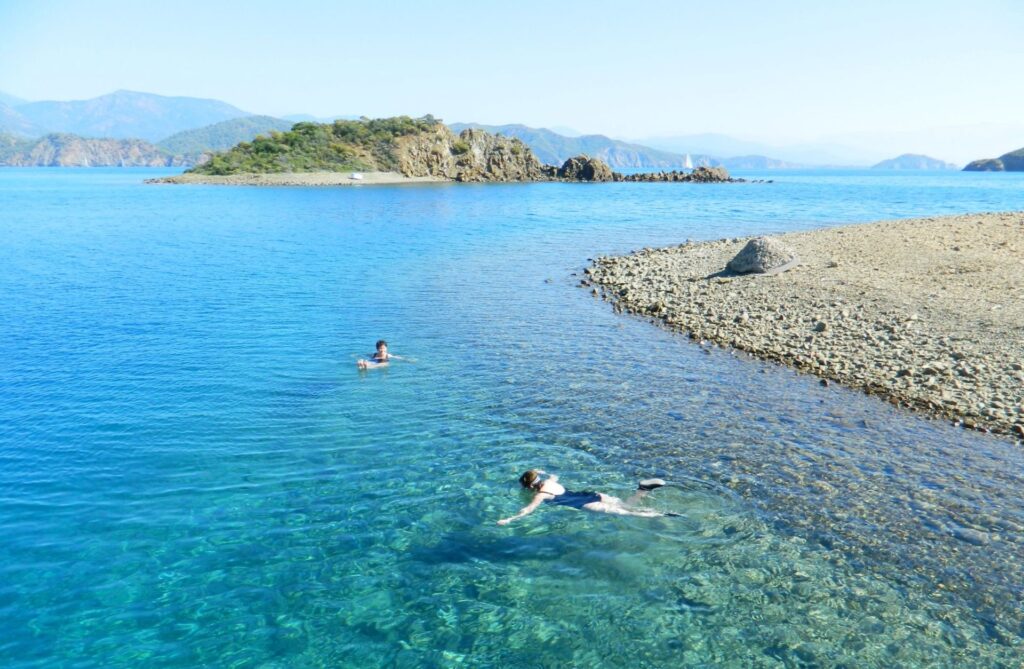 Blue sea and swimming scuba divers in Turkey on singing holiday